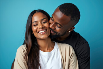 Fototapeta premium Young couple sharing affection against a blue background
