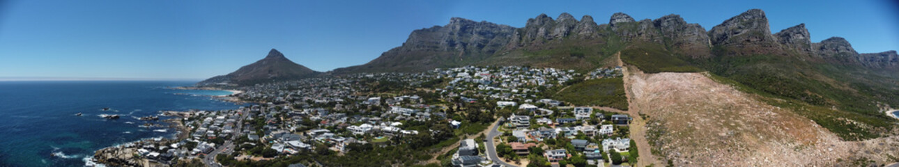 Obraz premium Camps Bay Cape Town South Africa Aerial Panorama with Signal hill and mountains in the background.