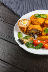 Tasty chicken rolls with potatoes and salad in a cozy spot