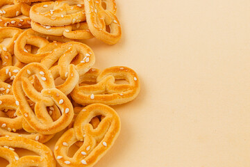 Delicious pretzels arranged on a soft yellow background for a tasty snack