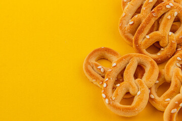 Pretzels arranged on a vibrant yellow background for a bold presentation