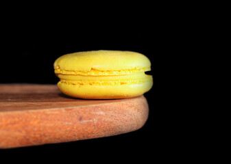 macaroon on a wooden board on a black background,