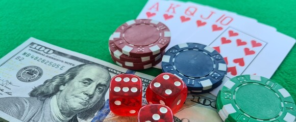 Poker cards royal flush, cash money dollar bills. Gambling, casino chips, dices