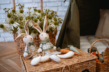 Handcrafted bunny dolls and decorative carrots in a cozy indoor setting