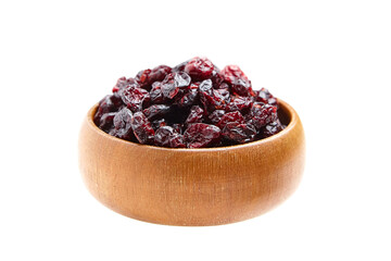 A wooden bowl brimming with dried cranberries featuring glossy, wrinkled textures and rich red...