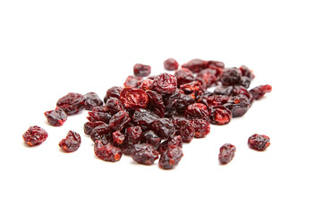 A scattered pile of dried cranberries with vibrant red tones, glossy surface, and wrinkled texture,...