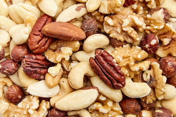 Assorted nuts including pecans, walnuts, almonds, cashews, hazelnuts, and Brazil nuts in a detailed close-up. Perfect for snacking and cooking