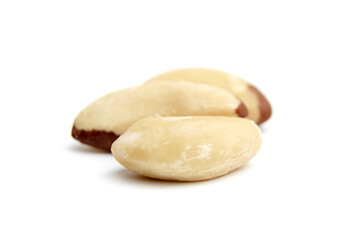Three Brazil nuts with smooth, creamy texture and brown skin patches, arranged on a white background, showcasing their natural detail