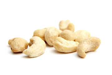 Close-up of raw cashew nuts scattered on a white surface. Perfect for illustrating healthy eating, plant-based diets, or natural food ingredients