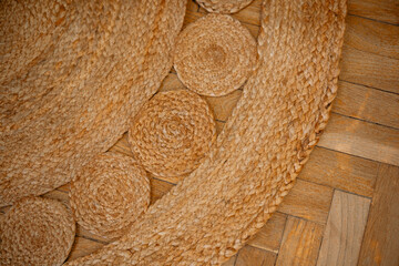Natural woven mat adds warmth to wooden floor in cozy interior space