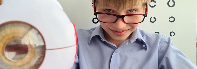Boy with glasses in ophthalmologist office concept