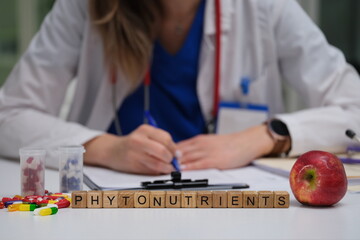 A dedicated healthcare professional is studying the beneficial phytonutrients found in an apple and...