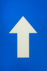 Fototapeta premium white arrow on a blue background pointing up