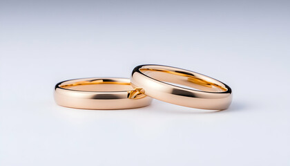 Gold wedding rings close-up on white background