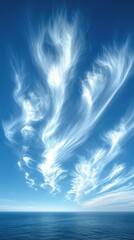 Serene Sky with Wispy Clouds Over Calm Ocean at Sunset, Ideal for Tranquil Nature Themes