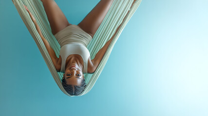 Graceful aerial yoga pose in hammock for relaxation and fitness