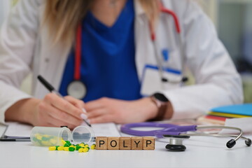 A healthcare provider records important information while a stethoscope and prescription medicines...