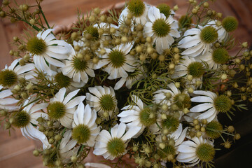 Beautiful arrangement of white flowers with green accents in a natural setting
