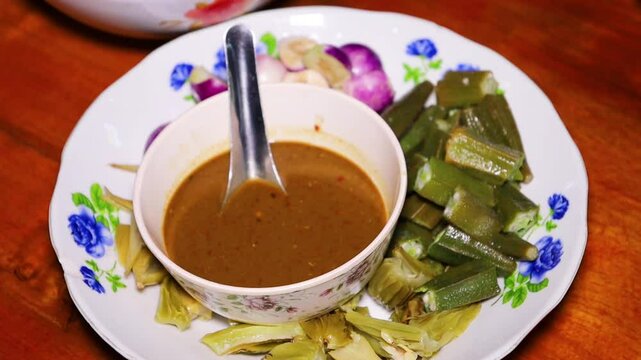Myanmar traditional Fish Preserve Sauce, which Burmese people call Ngapi yay and various boiled vegetables are sweet and delicious, Purple Eggplant, and okra.