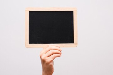 Woman's hand showing chalkboard. Place for writing text on a blackboard. Hands holding a empty black board on white