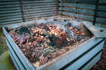 Compost heap in a suburban area with food waste and other organic matter. Making organic fertilizer...