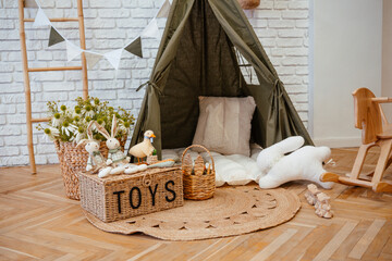 Cozy play area featuring a kids' tent and plush toys in a bright room