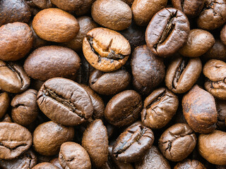 Extreme macro photo of scattered coffee beans, close-up from above