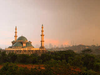 A view of Masjid Wilayah mosque in Kuala Lumpur, Malaysia with Kuala Lumpur city on background.