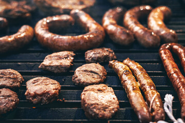 Grilled Sausages and Patties on BBQ Grill Cooking