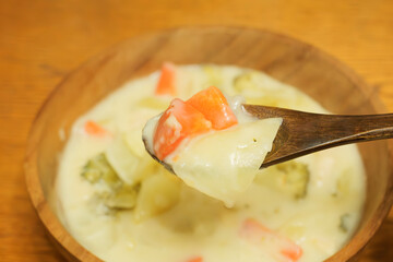 Trying to eat warm milk stew with a spoon
