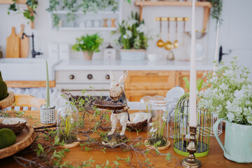 Easter decor adorns a rustic kitchen table with natural greenery