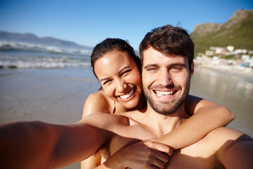 Fototapeta premium Beach, selfie and happy couple hug with holiday, love and bonding in nature for outdoor adventure. Ocean, man and woman embrace on romantic island vacation with photography, smile and fun travel