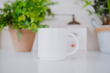 Warm ceramic mug placed on a table among indoor plants