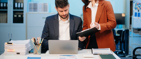 Female discussing new project with male colleague. Young woman talking with young man
