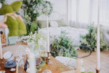 Spring decoration setup in a cozy room with greenery and candles