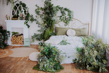 Cozy bedroom with natural decor and greenery surrounding the bed