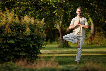 Yoga, tree pose and portrait of man in garden for balance, wellness and peace for holistic fitness....