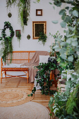 Cozy indoor space featuring plants, decorative elements, and seating arrangement