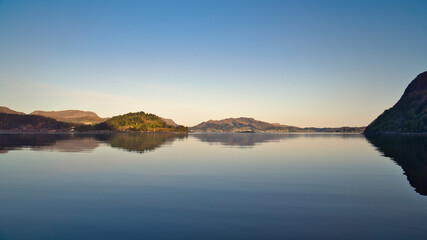 Fjord with view of mountains and fjord landscape in Norway. Blue sky