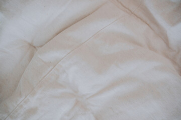 Soft white bedding arranged neatly on a cozy inviting bed during the day