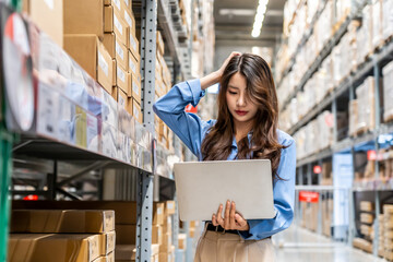 Large storage facility, Young asian woman diligently checking her clipboard as she organizes and oversees the supplies, but she forgot detail, feeling stressed, mistake while Exploring the warehouse