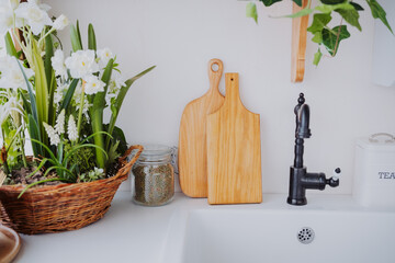 Elegant kitchen countertop with wooden boards and fresh floral arrangements
