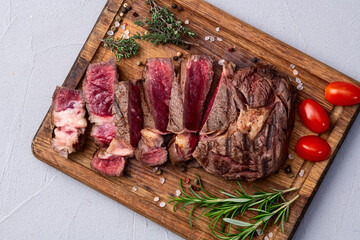 Ribeye grilled  beef steak sliced . Rare doneness photography . Top view