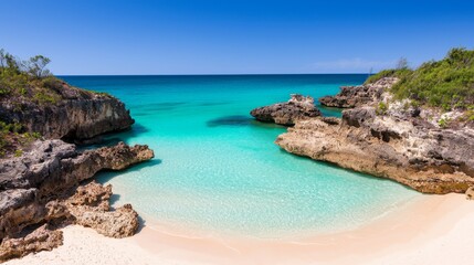 Naklejka premium Secluded Beach Cove with Crystal Clear Waters Under a Bright Blue Sky
