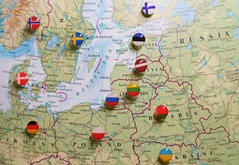 A close-up of a map focused on the Baltic Sea region, Eastern Europe, Scandinavia, with pushpins marking various locations and national flags indicating the countries.