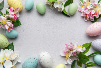 Pastel easter eggs and blossoms in a circular arrangement