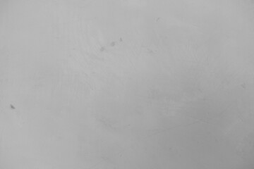 A soft gray surface displaying a minimalistic texture with faint markings