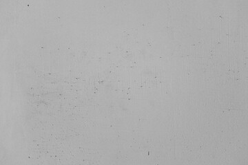 Textured gray wall featuring subtle scratches and marks in urban setting