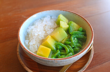 Bowl of Iced Fragrance and Sweet Lod Chong Pandan Noodles in Coconut Milk with Ripe Thai Melon