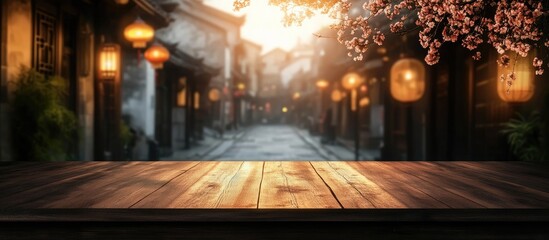 Dark wooden table in foreground with unoccupied space for text, blurred street view with soft golden lighting and lantern accents in background.